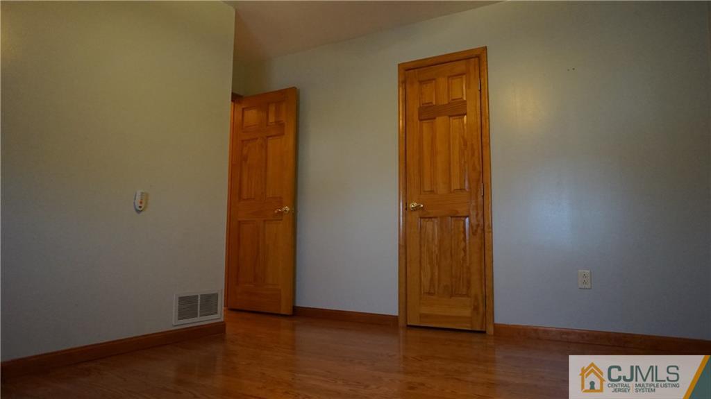 8 Plumstead Road Sewell, NJ 08080 - Photo 18 of 25 an empty room with wooden floor and closet