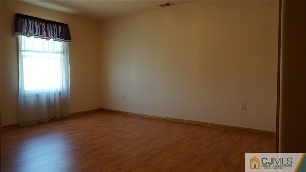 8 Plumstead Road Sewell, NJ 08080 - Photo 22 of 25 an empty room with wooden floor and windows