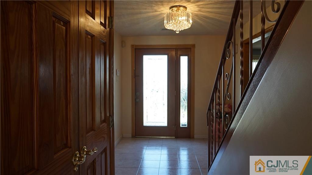 8 Plumstead Road Sewell, NJ 08080 - Photo 10 of 25 a view of an entryway with a mirror