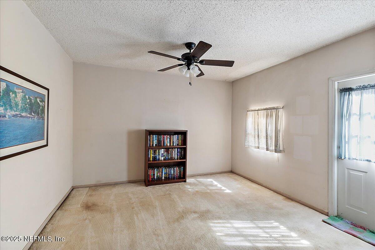 3608 Chappi Way Jacksonville, FL 32223 - Photo 11 of 14 a view of a livingroom with a ceiling fan and window