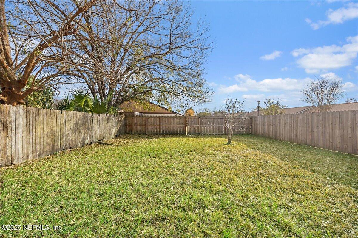 3608 Chappi Way Jacksonville, FL 32223 - Photo 13 of 14 a view of a backyard with tree s