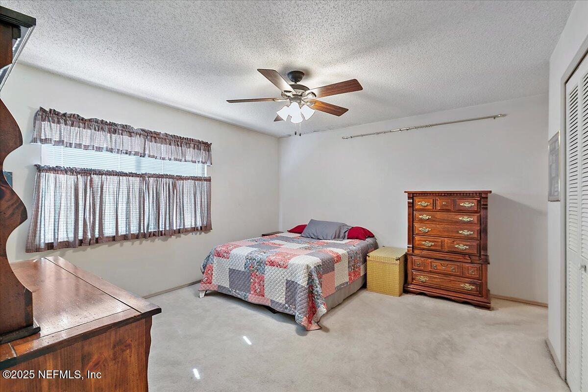 3608 Chappi Way Jacksonville, FL 32223 - Photo 9 of 14 a bedroom with a bed and a ceiling fan
