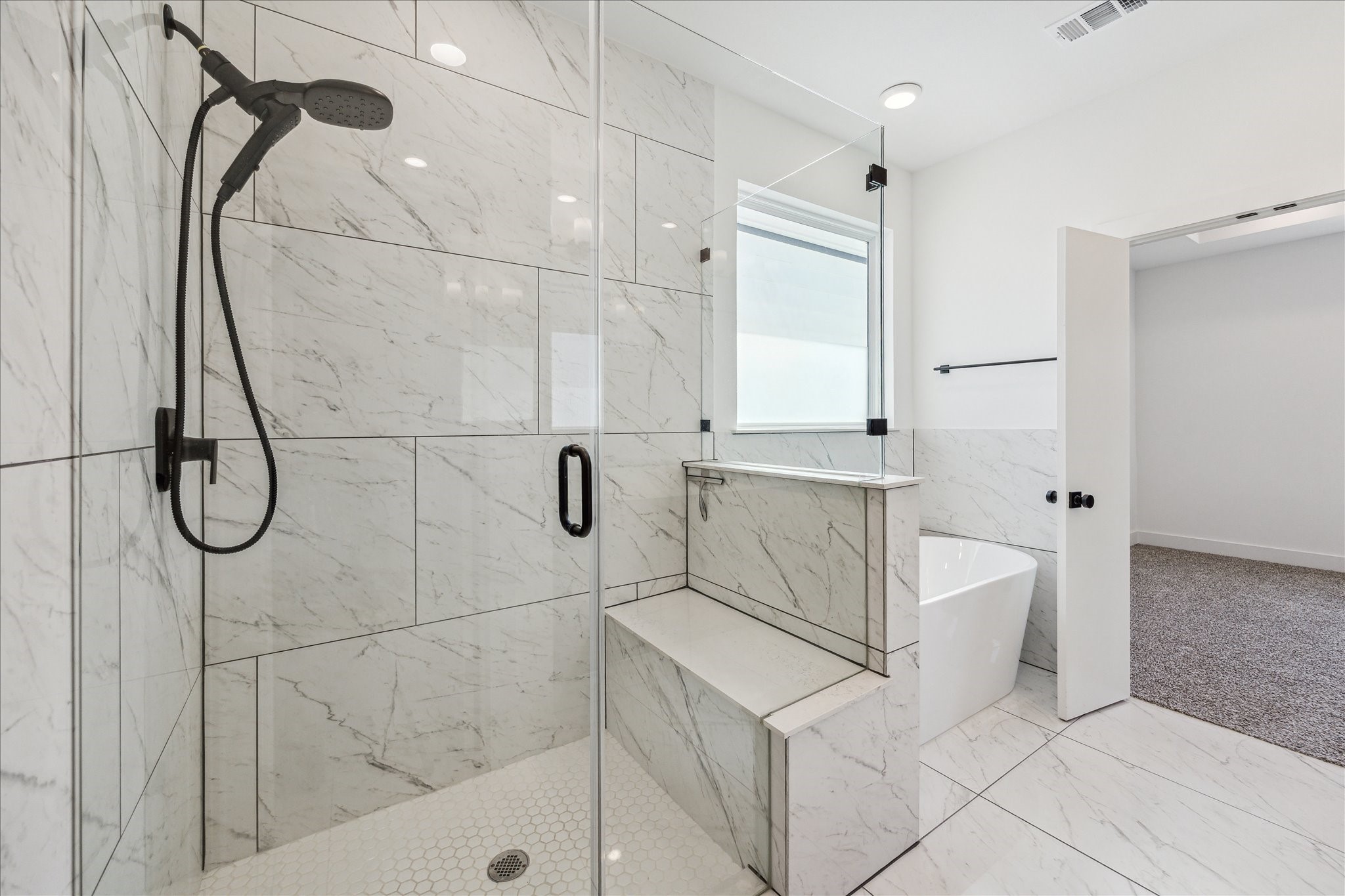 4854 Brinkman Street Houston, TX 77018 - Photo 15 of 30 Take another look at this gorgeous walk-in frameless glass shower with beautiful tile, and built-in bench seating!