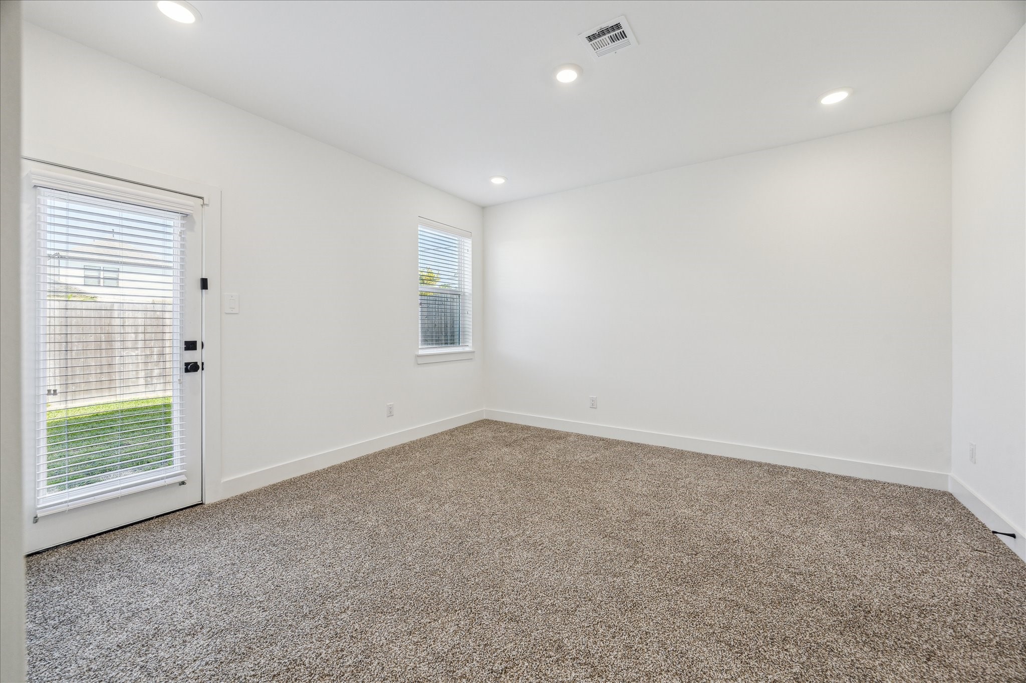 4854 Brinkman Street Houston, TX 77018 - Photo 18 of 30 Versatile first-floor bedroom featuring soft carpet, natural and recessed lighting also features direct access to the backyard.