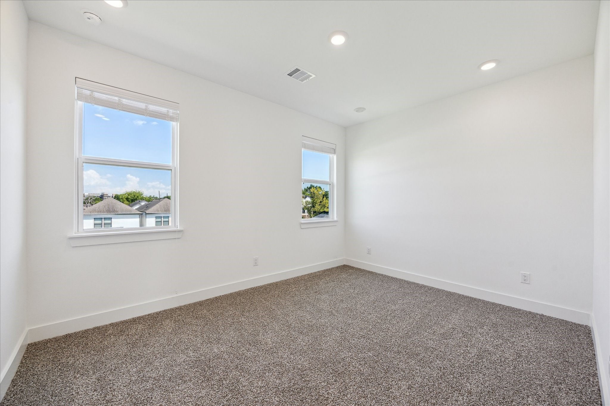 4854 Brinkman Street Houston, TX 77018 - Photo 20 of 30 Inviting secondary bedroom featuring plush carpet, modern recessed lighting, and windows that bring in beautiful natural light.
