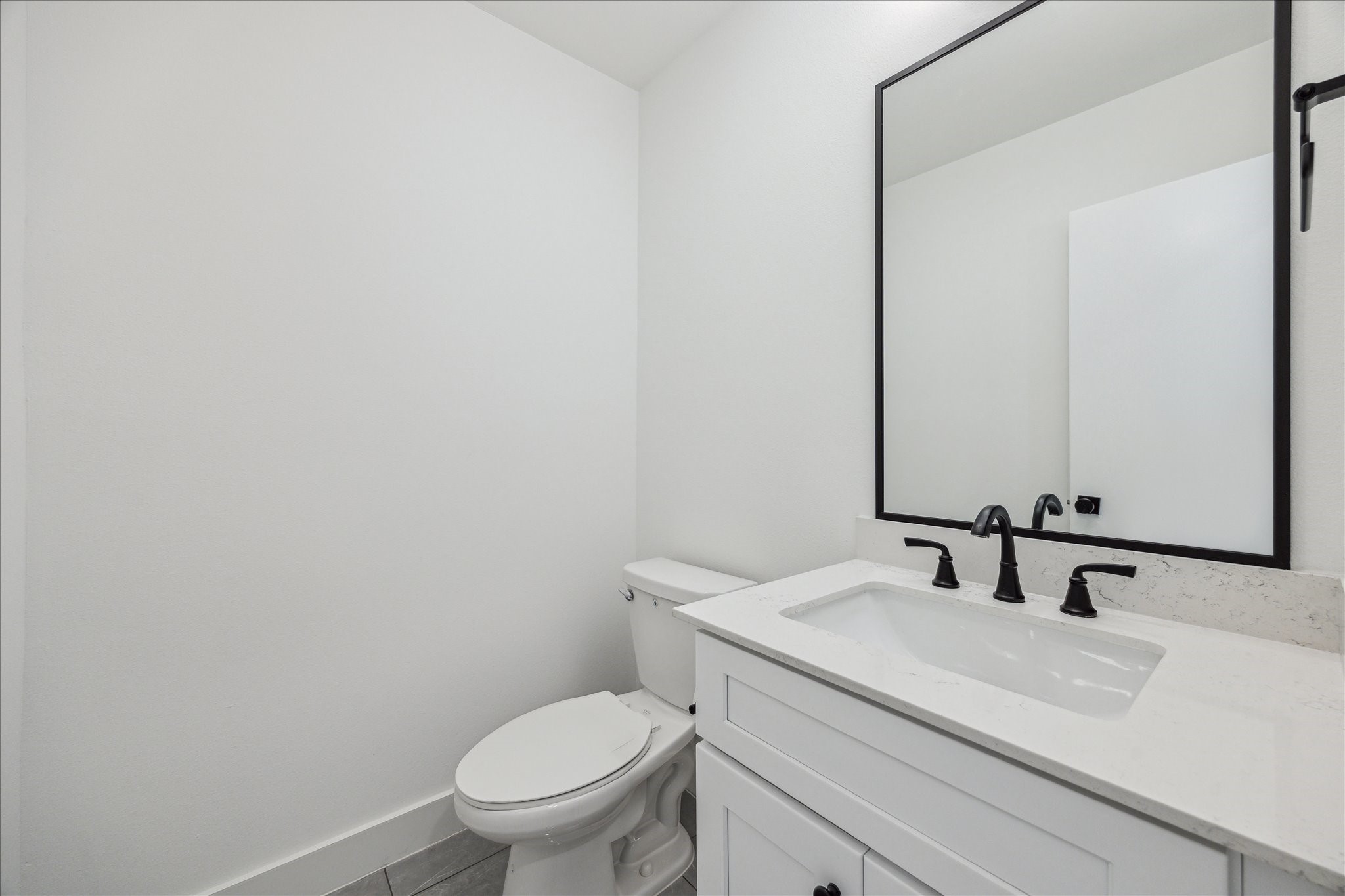 4854 Brinkman Street Houston, TX 77018 - Photo 10 of 30 Convenient second-floor half bath with modern fixtures, quartz vanity, and sleek black accents.