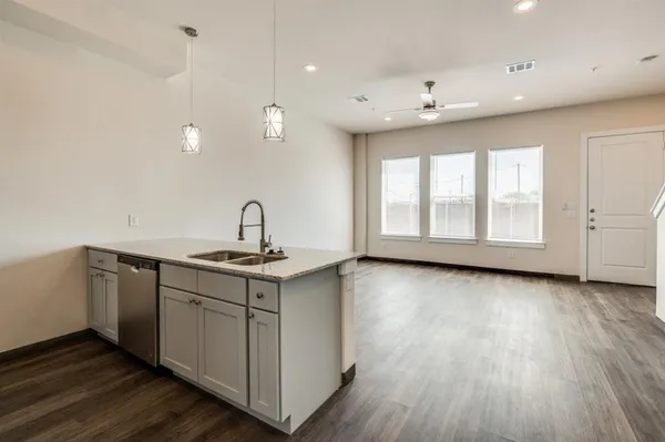a view of a kitchen with a sink and a refrigerator