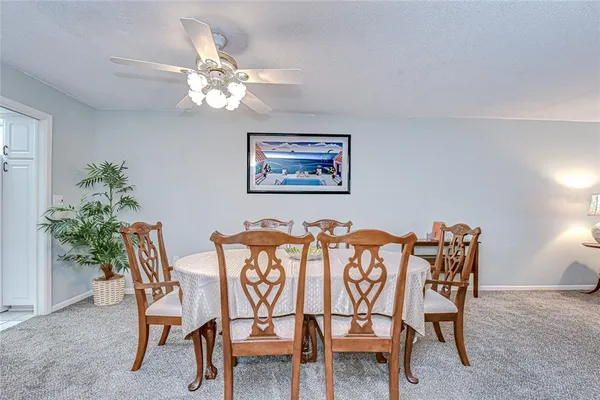 a view of a a dining room with furniture window and wooden floor