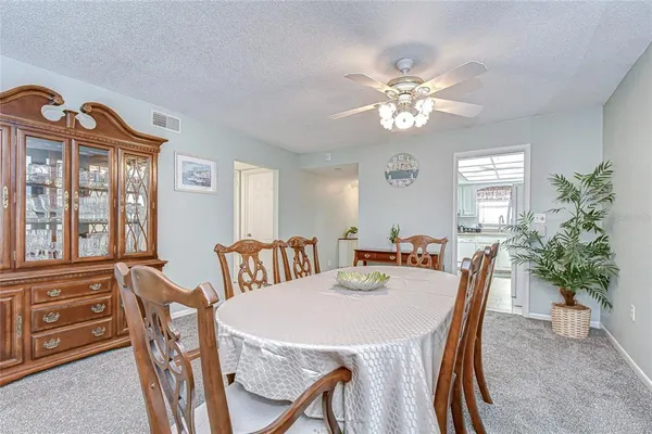 a view of a dining room with furniture and chandelier