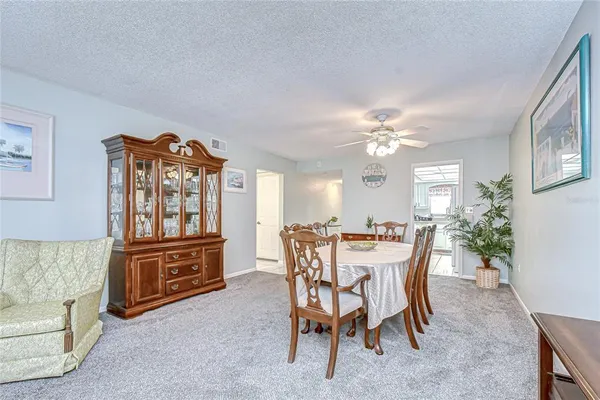 a living room with furniture flat screen tv and window