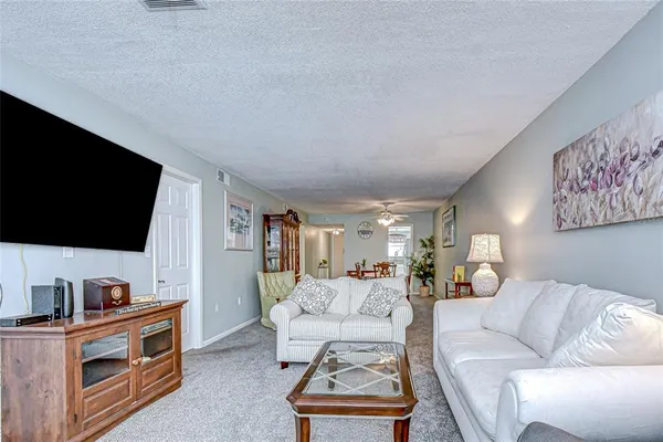 a view of a livingroom with furniture and workspace