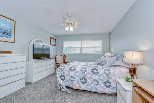 a bedroom with a large bed and a chandelier