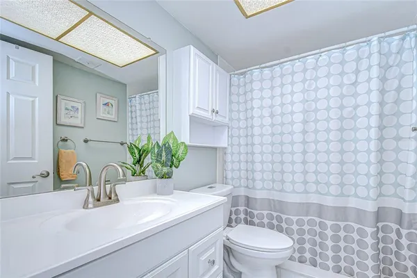 a view of walk in closet with clothes