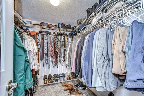 a bedroom with two beds and a chair