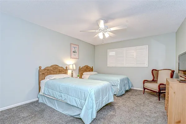 a bedroom with two beds and a chandelier
