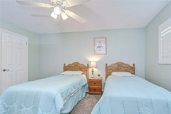 a bathroom with a granite countertop sink a toilet and a mirror