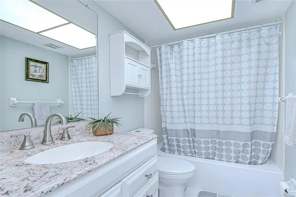 a view of a house with a yard and palm trees