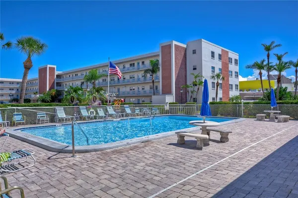 a view of a swimming pool and an outdoor seating