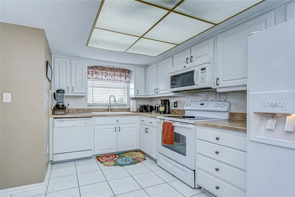 a kitchen with cabinets appliances and a sink