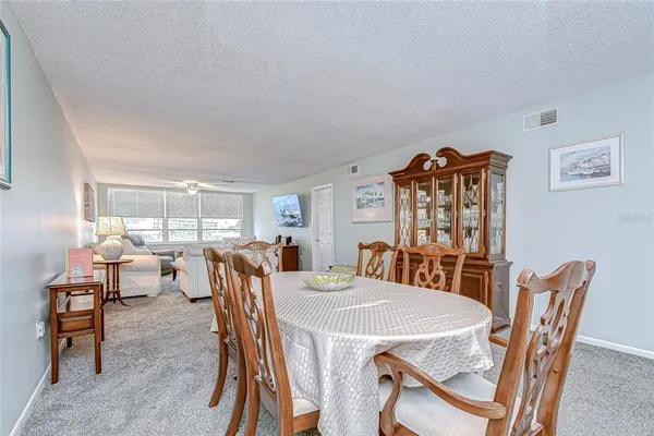 a dining room with furniture and chandelier