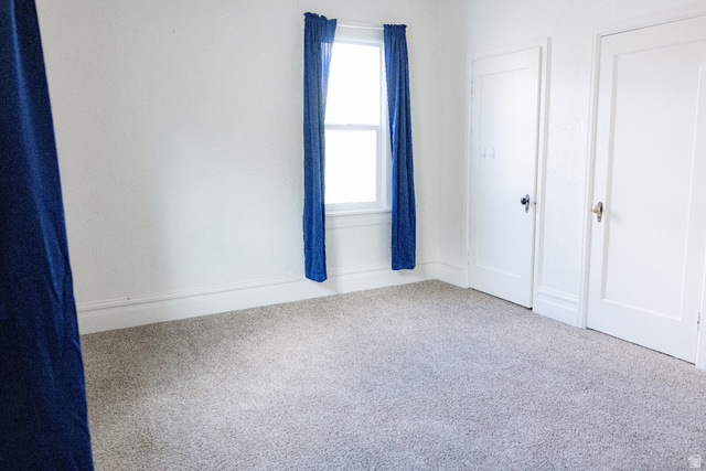 69 South Main Street Manti, UT 84642 - Photo 36 of 44 Bright interior room featuring light-colored carpeting and white walls