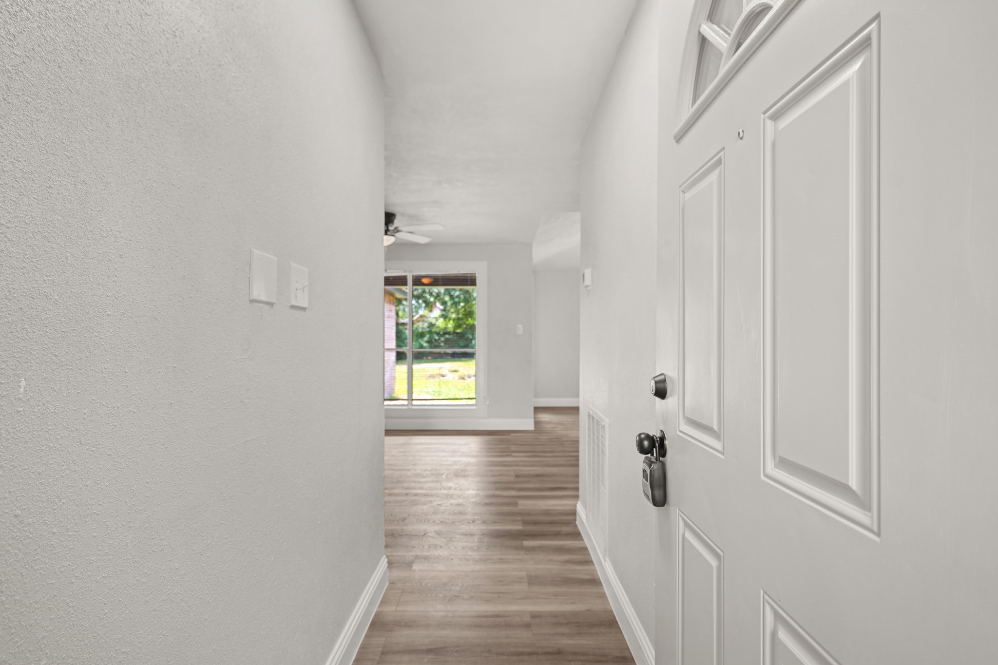 3623 Peachstone Place Spring, TX 77389 - Photo 3 of 20 a view of a hallway with wooden floor and a window