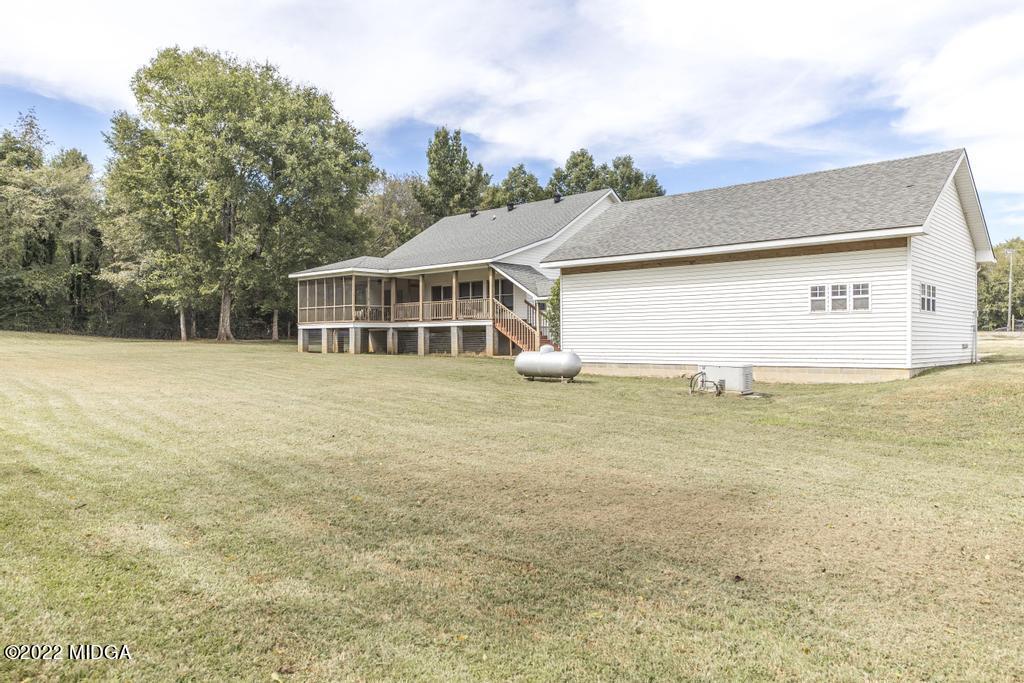 911 Lassiter Road Forsyth, GA 31029 - Photo 13 of 55 a view of a house with a yard and tree s