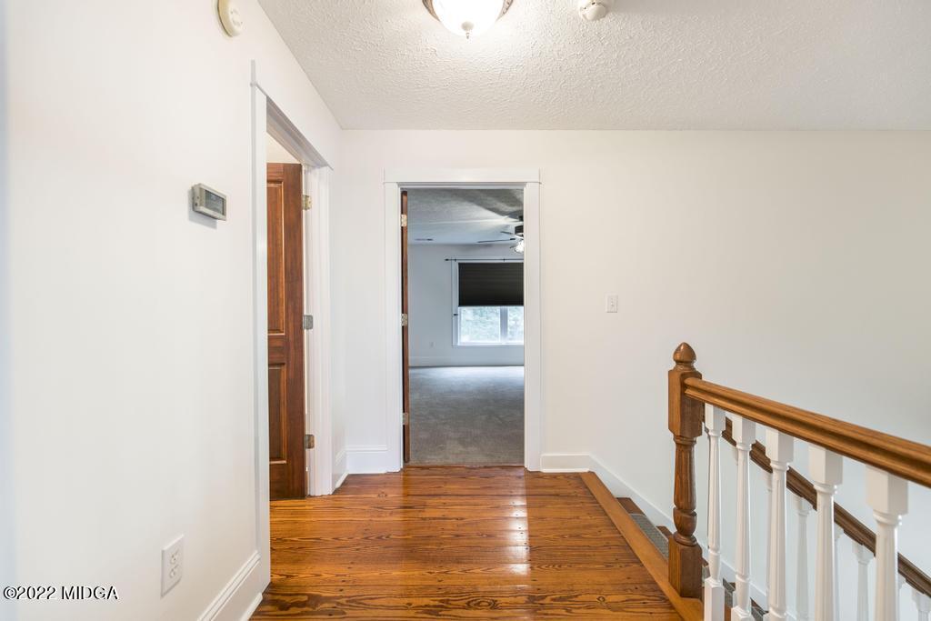 911 Lassiter Road Forsyth, GA 31029 - Photo 39 of 55 a view of a hallway with wooden floor and staircase