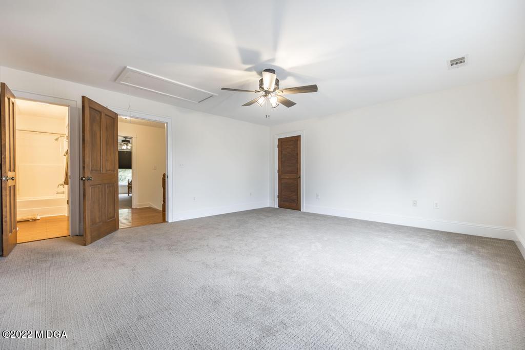911 Lassiter Road Forsyth, GA 31029 - Photo 41 of 55 a view of a big room with chandelier fan and windows