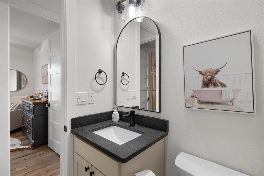 476 Silverleaf Drive Sunset, TX 76270 - Photo 17 of 40 a bathroom with a toilet sink and mirror