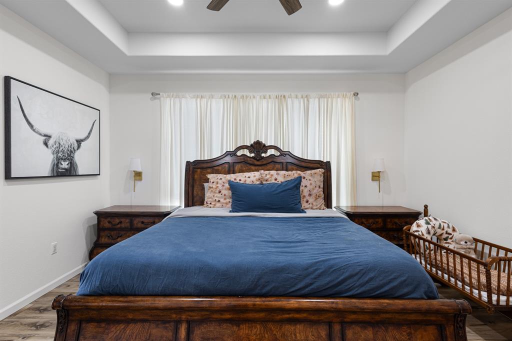476 Silverleaf Drive Sunset, TX 76270 - Photo 19 of 40 a bedroom with a bed and painting on the wall