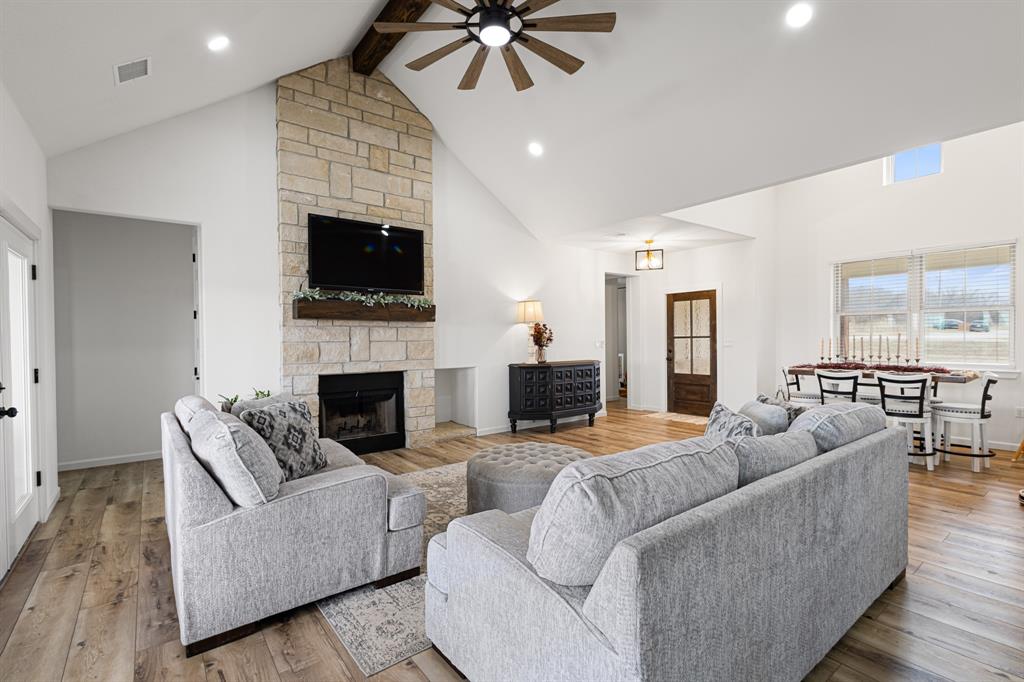 476 Silverleaf Drive Sunset, TX 76270 - Photo 5 of 40 a living room with furniture a flat screen tv and a fireplace