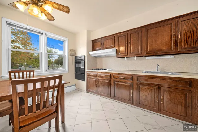 a kitchen with stainless steel appliances granite countertop a stove sink and cabinets