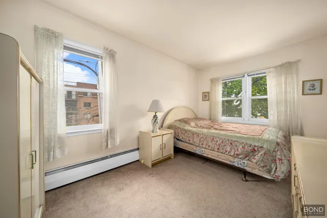 a bed sitting in a room next to a window