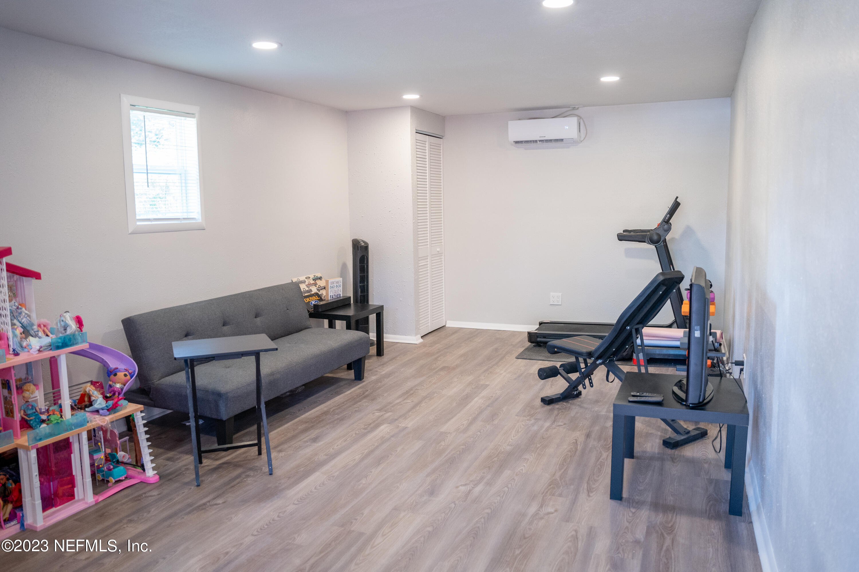 9008 Old Kings Road Jacksonville, FL 32219 - Photo 22 of 22 a living room with furniture a air conditioner vent and a wooden floor