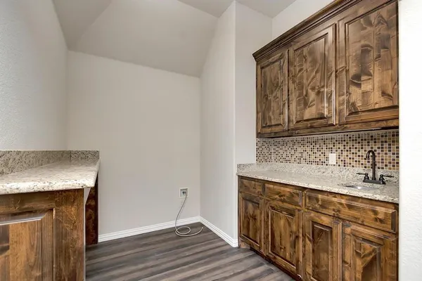 a kitchen with stainless steel appliances granite countertop a sink and dishwasher with wooden floor