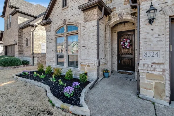 a front view of a house with a garden
