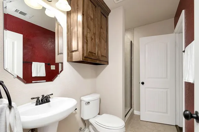 a white toilet sitting next to a bathroom sink