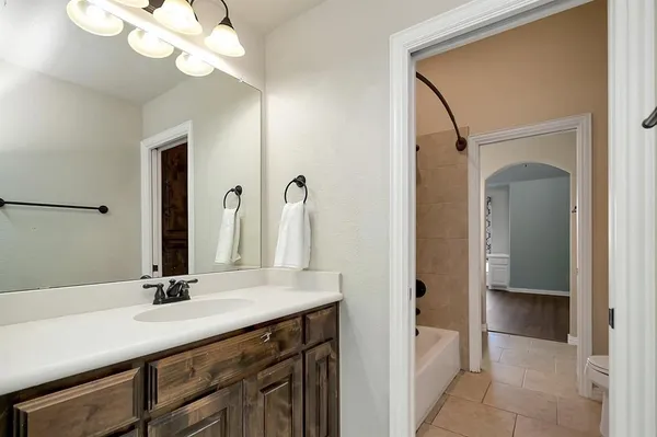 a bathroom with a sink a light fixture and a mirror