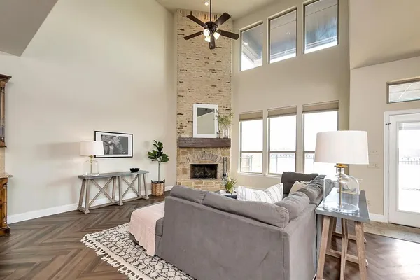 a living room with furniture a fireplace and a table