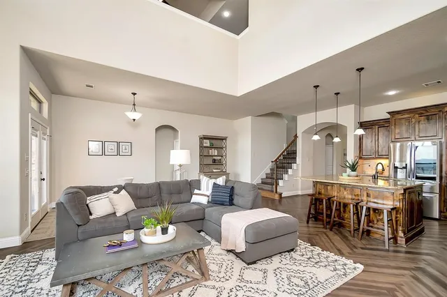 a living room with lots of furniture and view of kitchen