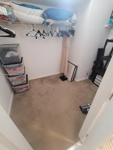 a bedroom with a bed and a night stand