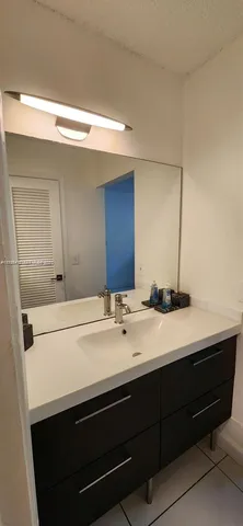 a bathroom with a double vanity sink and mirror