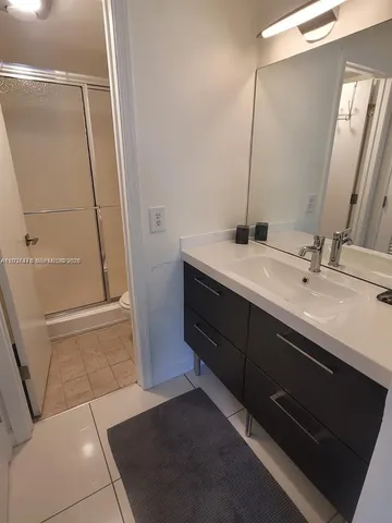 a bathroom with a glass shower door