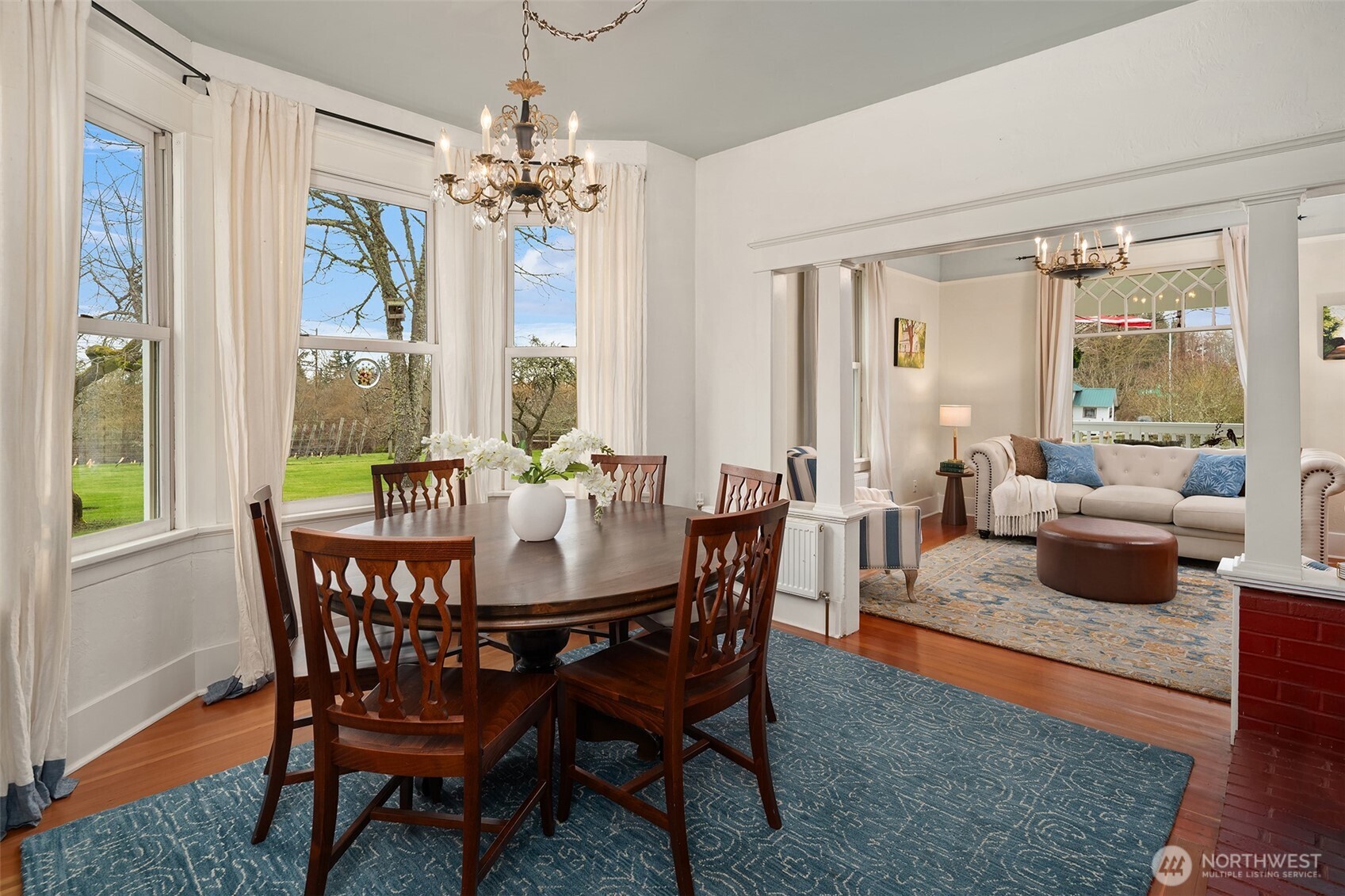 6007 Southwest 240th Street Vashon, WA 98070 - Photo 15 of 40 a view of a dining room with furniture wooden floor and chandelier