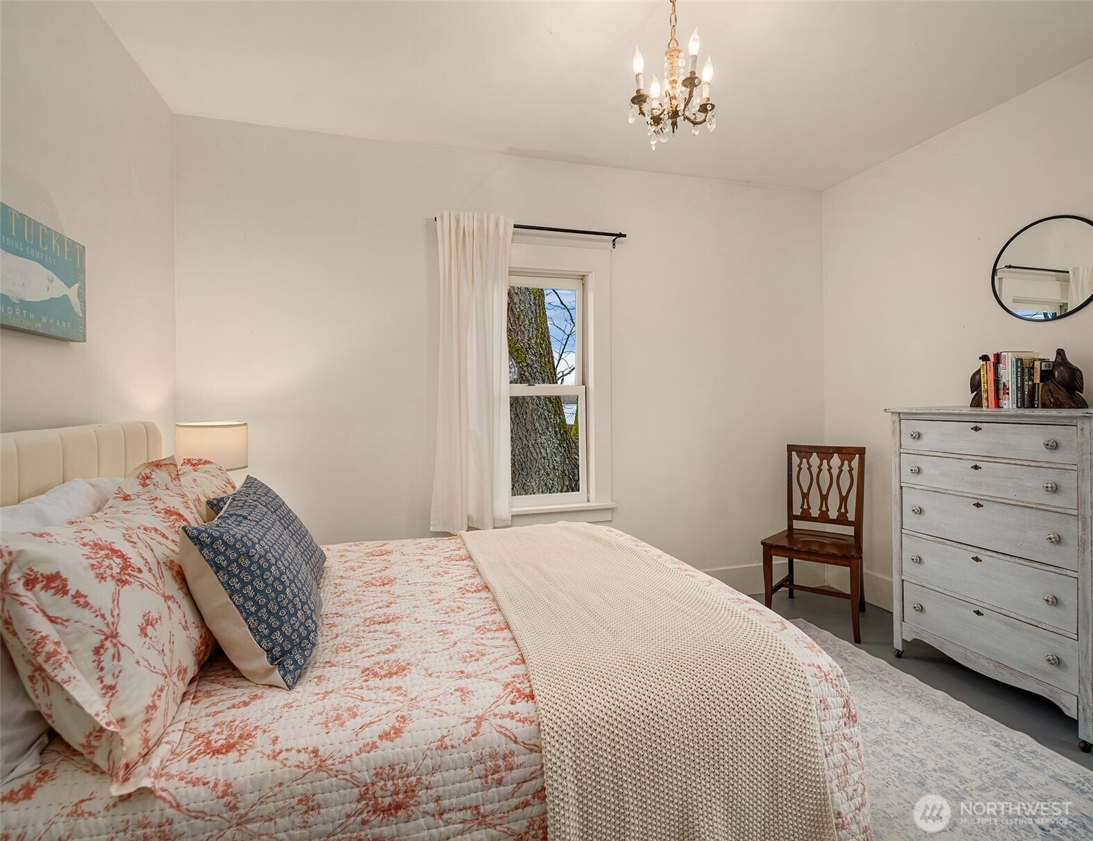 6007 Southwest 240th Street Vashon, WA 98070 - Photo 18 of 40 a bedroom with a bed and a chandelier