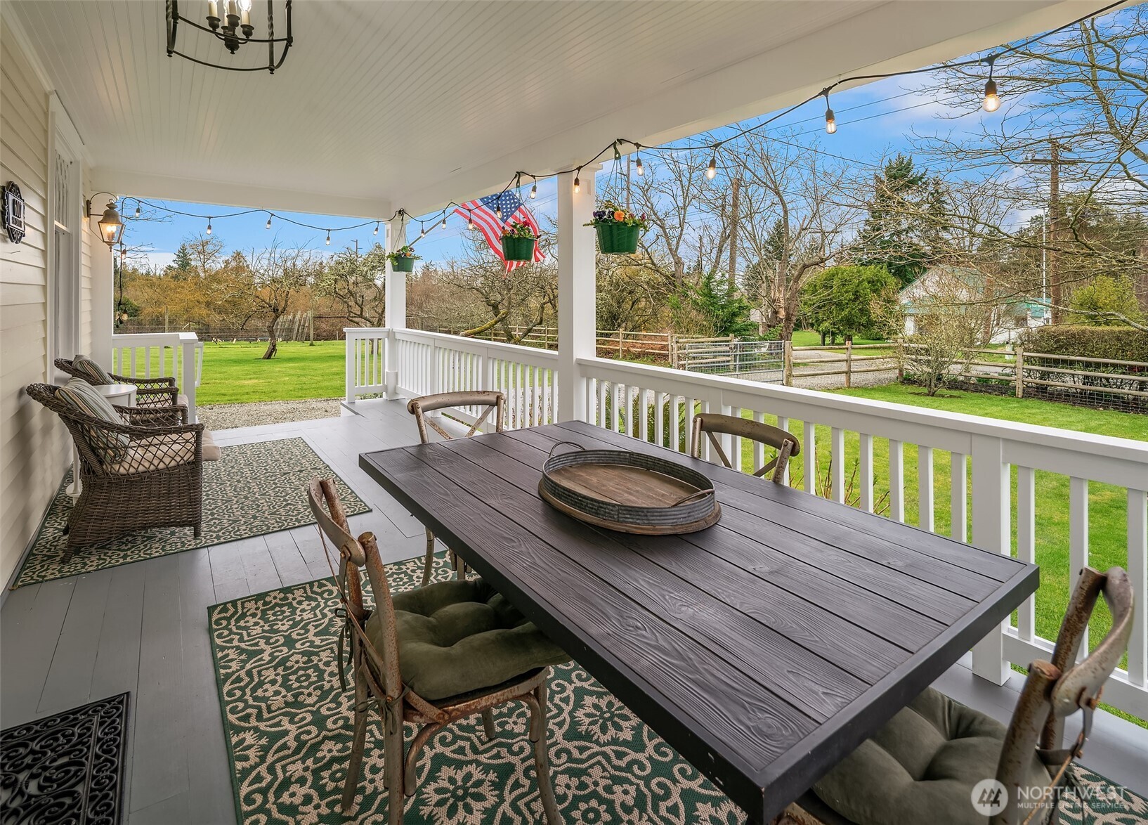 6007 Southwest 240th Street Vashon, WA 98070 - Photo 2 of 40 a view of a patio with wooden floor table and chairs