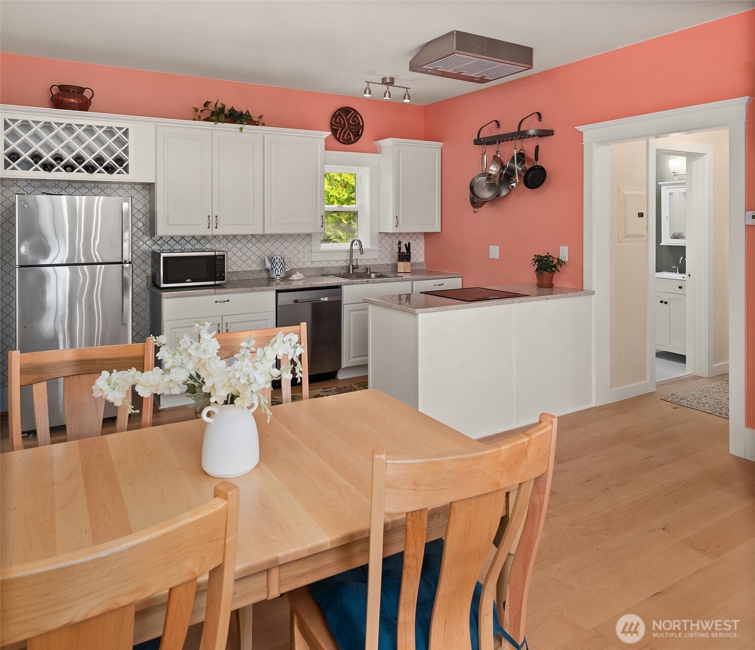 6007 Southwest 240th Street Vashon, WA 98070 - Photo 23 of 40 a kitchen with a table chairs and a refrigerator