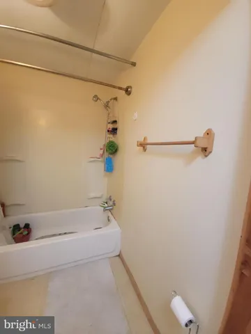 a bathroom with a bathtub and shower