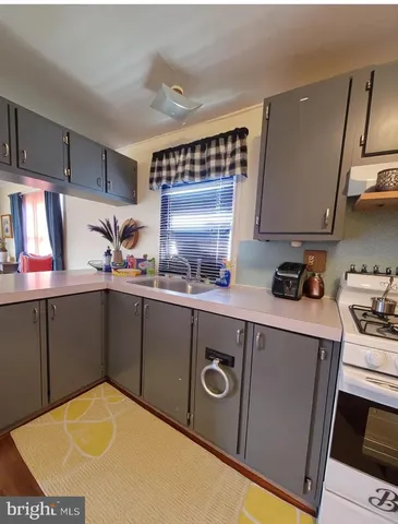 a kitchen with stainless steel appliances a sink a stove and a refrigerator